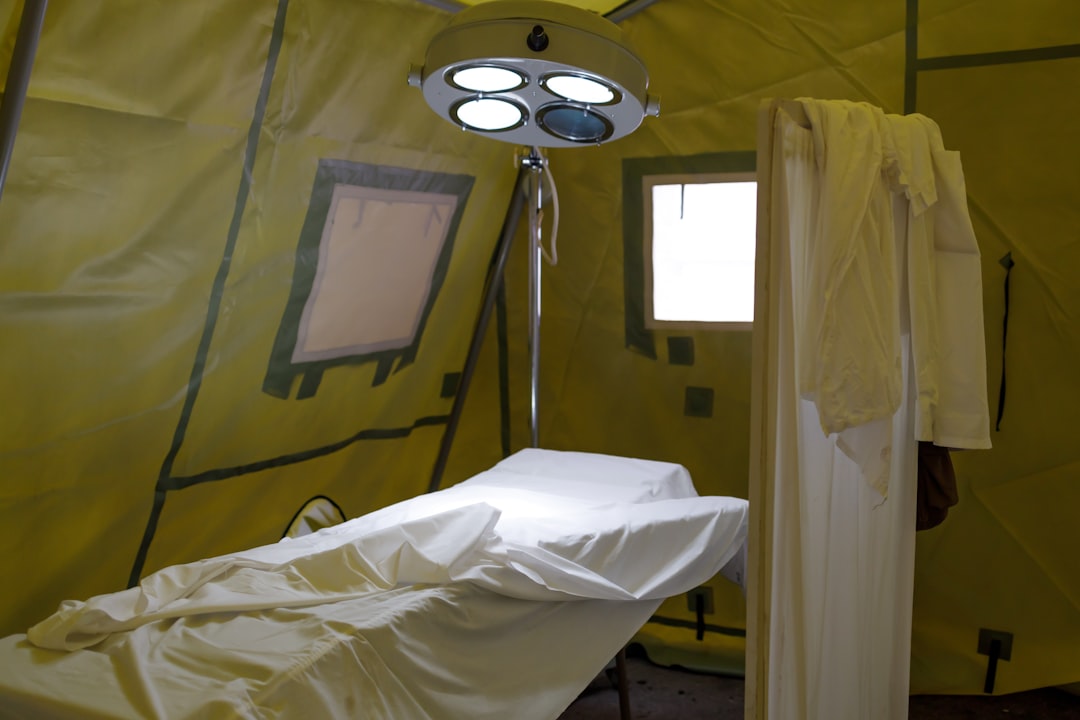 Empty hospital operating theatre with ceiling ventilation, the type of controlled environment tested against ISO 14644 limits